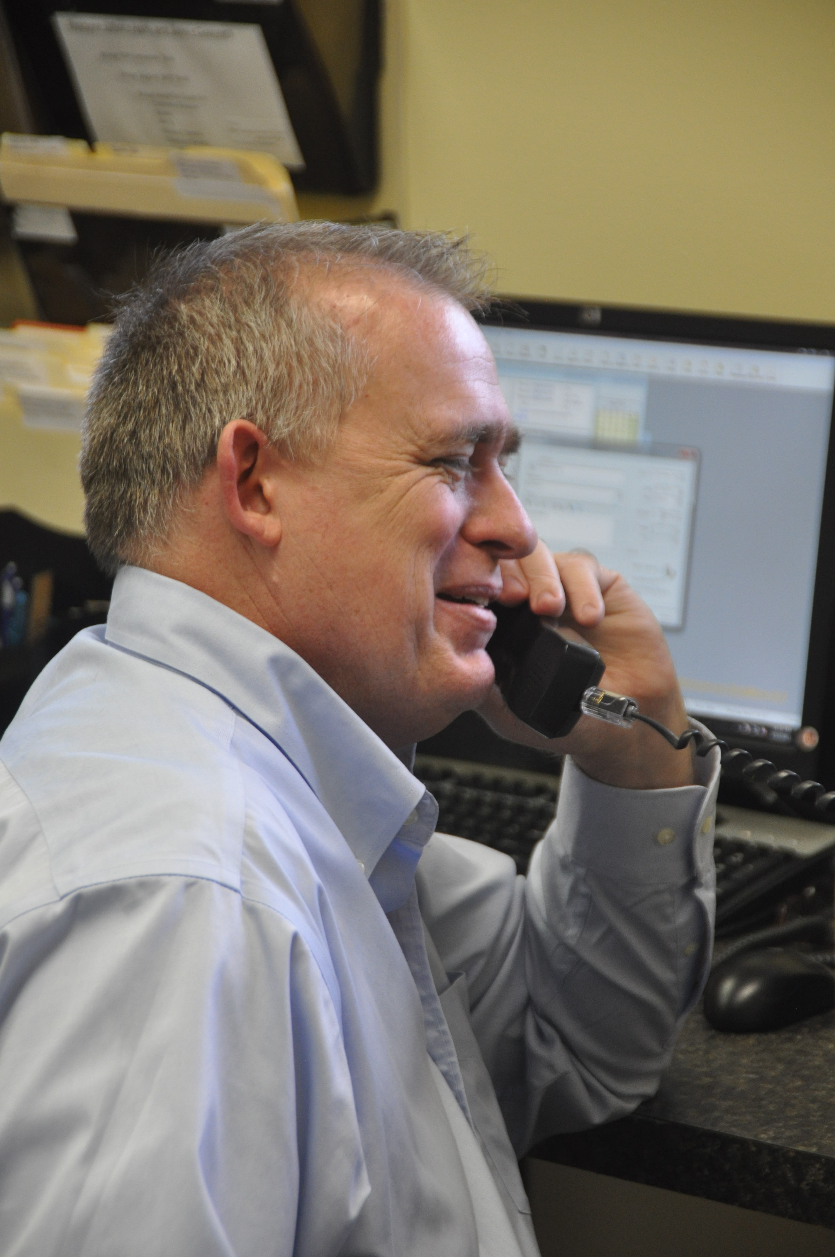 ImageOne team member answering a client call at the Maitland office